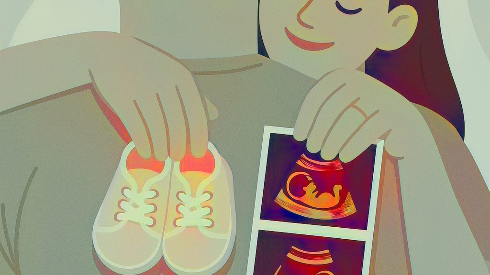 Pregnant couple with sonar of baby and a pair of baby shoes